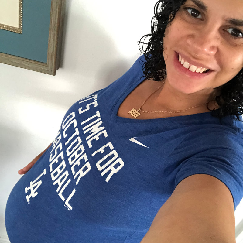 A pregnant Li Yun wearing a t-shirt that says: It's time for October Baseball
